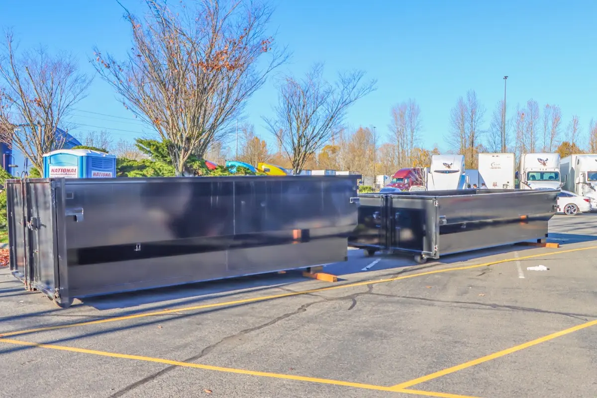 Professional dumpster rental service with roll-off container on residential driveway in Auburn